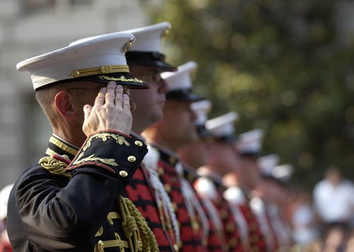 a picture of a line-up of US navy saluting.